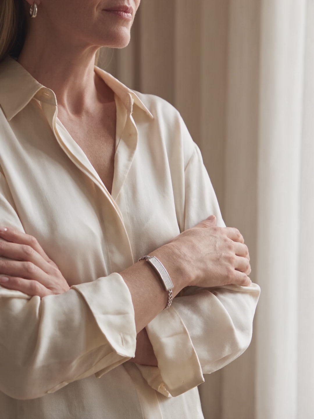Woman wearing the VitalVibe Bracelet in Crystal Silver